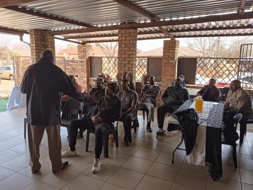 a man shaking hands with a group of people at Prison View Guesthouse 2 in Klerksdorp