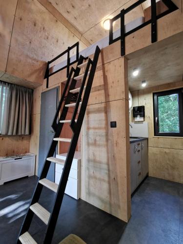 a loft bed in a tiny house at TREE-TOP VILLAGE, Tokajské domčeky v korunách stromov in Malá Bara