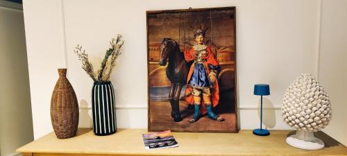 a painting of a woman with a horse on a wall at Villebe Mondello in Mondello