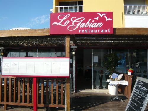 a restaurant with a sign that reads la falena restaurant at Hôtel Port Beach in Gruissan