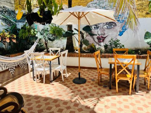 a table and chairs with an umbrella in a restaurant at Casa Isabelita in Mompos