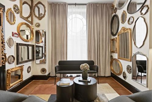 a living room with mirrors on the walls at Brexton Hotel in Baltimore