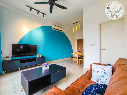 a living room with a couch and a tv at Pangsapuri Meridian by RR JBcity in Nusajaya
