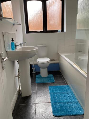 a bathroom with a sink and a toilet and a tub at Oasis in Buckinghamshire