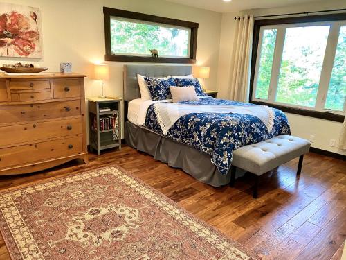 a bedroom with a bed and a dresser and a window at Avenue of the Giants River View Home (#1) 