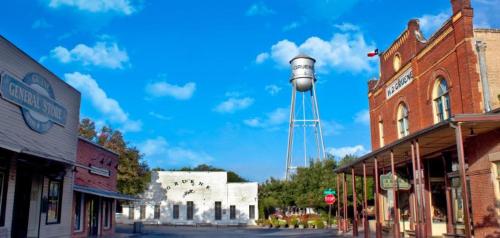 a town street with a water tower in the background at Sunset Ridge 2King Beds Lake Hot Tub Pool in Canyon Lake