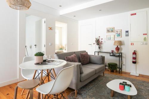 a living room with a couch and a table at Porto Insight Apartments Campanhã in Porto