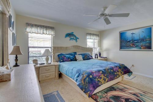 a bedroom with a bed and a ceiling fan at The Marco Mariner in Marco Island