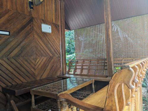 an inside of a room with a table and chairs at K V Wooden Homestay in Varkala