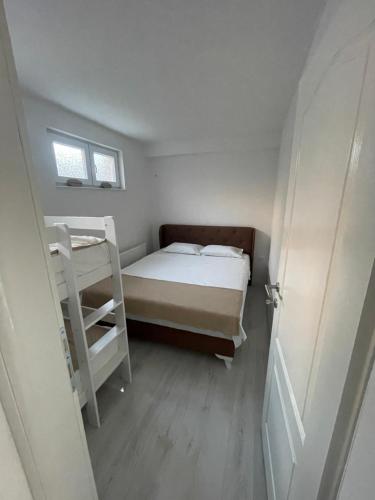 a small bedroom with a bed and a ladder at Apartment Herceg Blagaj in Blagaj