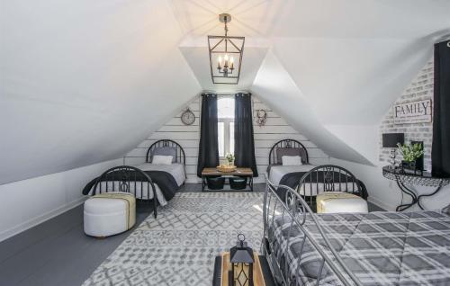 a attic room with four beds and a staircase at Atlantic Shores Retreat in Port Dufferin