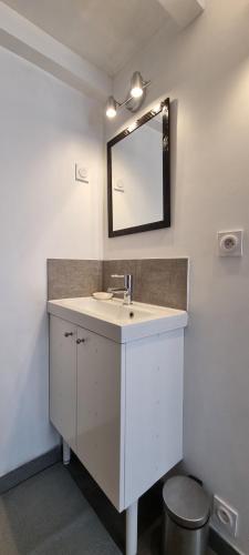 a bathroom with a sink and a mirror at Le Studio de Véra - Intra Muros - Wifi in Avignon