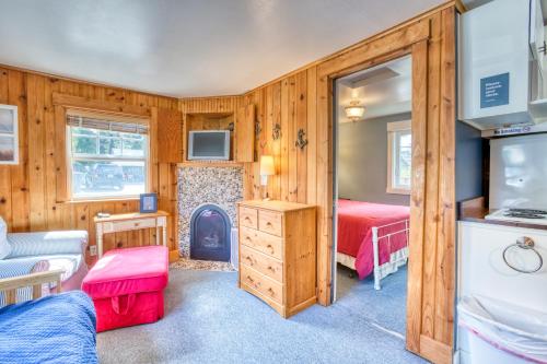 a bedroom with two beds and a fireplace at Hidden Villa Cottages #1, #2, and #3 in Cannon Beach