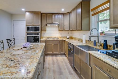 a kitchen with wooden cabinets and granite counter tops at Hot Tub and Lake Access Spacious Tobyhanna Home in Tobyhanna