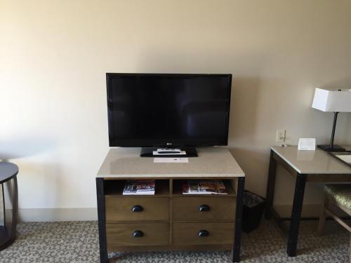 a television on a dresser in a hotel room at Ponte Vineyard Inn in Temecula