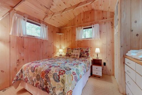 a bedroom with a bed in a wooden cabin at Brandy Shores in Naples