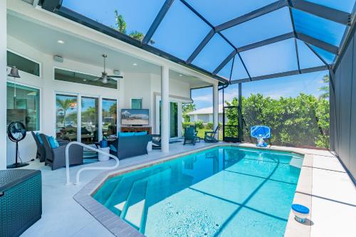 an indoor swimming pool in a house with a glass ceiling at The Goldenrod House I Ultimate Escape on Marco Island in Marco Island
