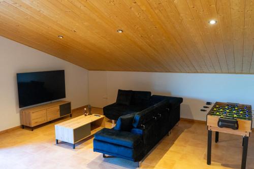 a living room with a couch and a flat screen tv at Cal Ganyada, Casa Rural Cardona in Cardona