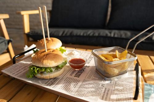a tray with two sandwiches and a basket of fries at Thermal Hotel Seven Seasons in Banya