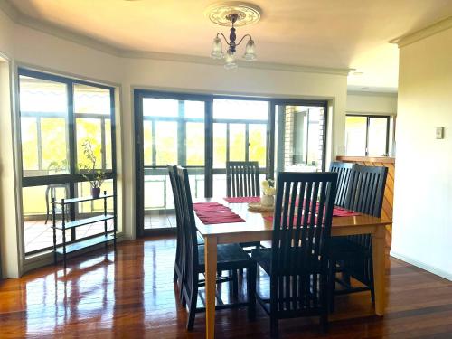 a dining room with a table and chairs in a room at Ocean View 3 bedroom entire house central of Caloundra in Caloundra West