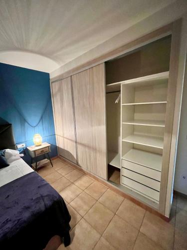 a bedroom with a bed and a walk in closet at Cal Ganyada, Casa Rural Cardona in Cardona
