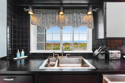 a kitchen with a sink and a window at Sea Dream and Sand Dollar Suite in Fort Bragg