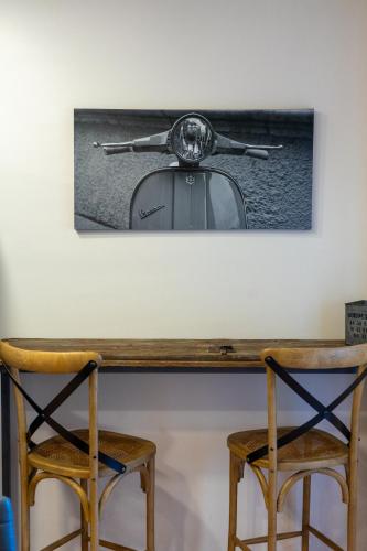 a table with two chairs and a tea kettle on top at Cal Ganyada, Casa Rural Cardona in Cardona
