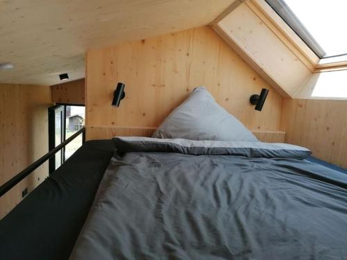 a bed in the middle of a tiny house at Tiny House 1 im schönen Allgäu mit großem Garten, Naturnah in Bad Wurzach