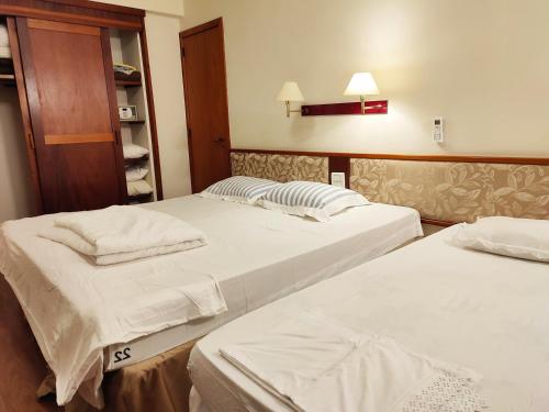 two beds in a hotel room with two at Suíte 455 Wish Resort Gramado in Gramado