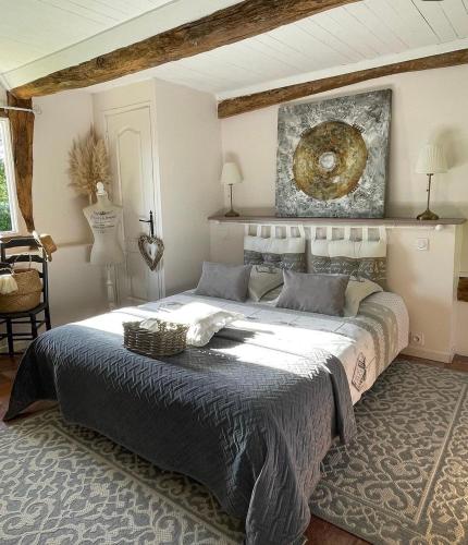 une chambre avec un grand lit dans une pièce dans l'établissement LES 2 CHAUMIÈRES Piscine & Spa, à Ablon