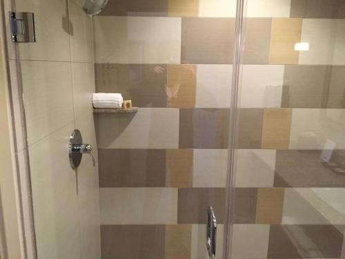 a shower with a glass door with a towel at Ponte Vineyard Inn in Temecula