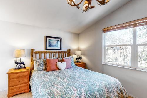 a bedroom with a bed and a window at Sun Bird Getaway at River Run in Ketchum