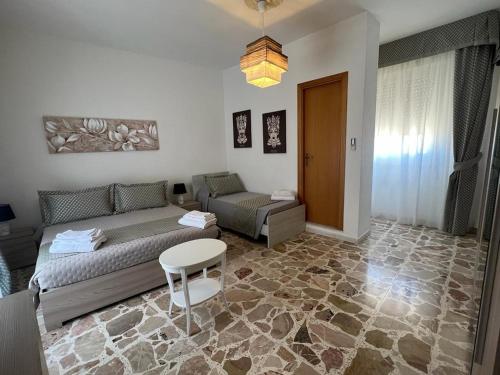 a living room with a couch and a table at Albemarooms in Noto
