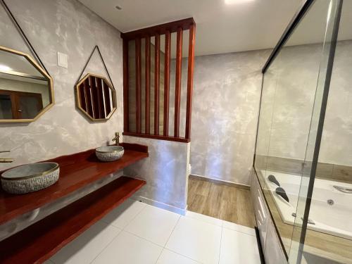 a bathroom with a sink and a shower at Pousada Sete Mares in Maragogi