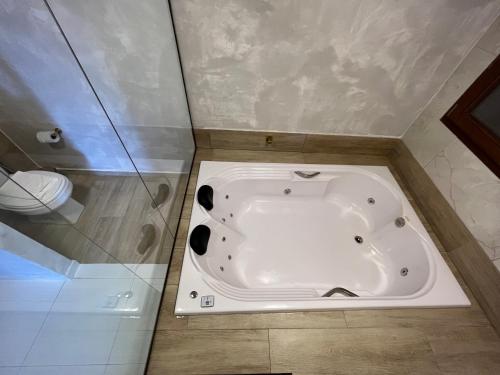 a bath tub in the corner of a bathroom at Pousada Sete Mares in Maragogi