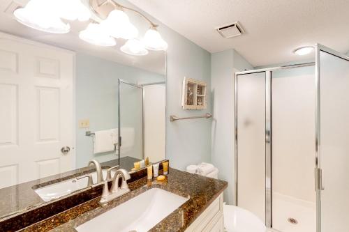 a bathroom with a sink and a shower at Pelican Beach Resort 1717 in Destin