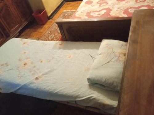 a wooden bed with a pillow on it at فندق جاردن رويال in Cairo