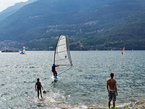 a group of people windsurfing in a lake at LA CASA DI MARIO in Perledo
