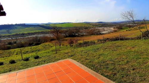 an orange tiled pathway in a field with a view at Villa Saturnia in Saturnia