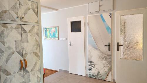 a room with a door with surfboards on the wall at Captain's Cottage 110m2, near Sopot, beaches, with a garden, grill & free parking in Gdańsk