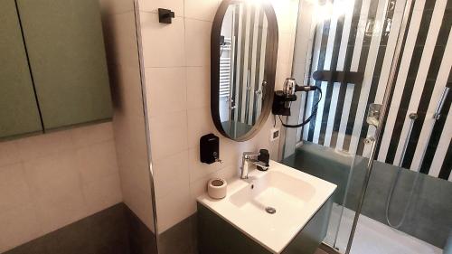 a bathroom with a sink and a mirror at Appartamento Sofia - CISE 18741 in Rome