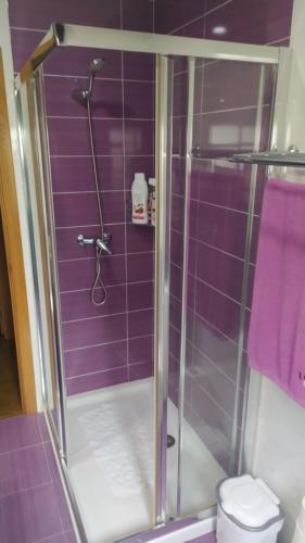 a purple bathroom with a shower with a toilet at Casa Lola in Oia