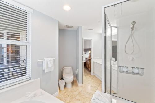 ein weißes Badezimmer mit Dusche und Toilette in der Unterkunft Beach Colony Resort West 10F in Navarre
