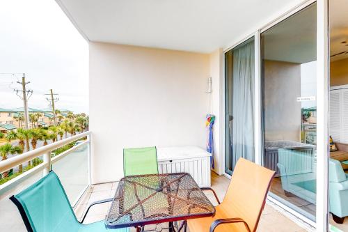 a balcony with a table and chairs on it at Destin West Resort - Gulfside V305 in Fort Walton Beach