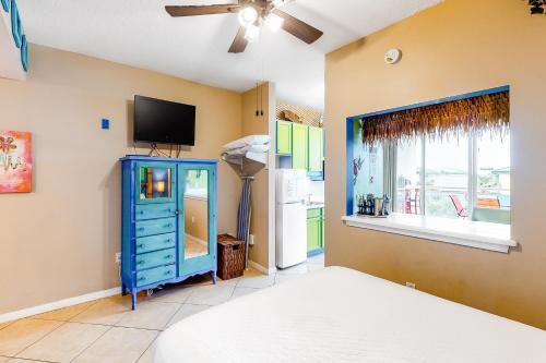 a bedroom with a blue dresser and a tv at Destin West Resort - Gulfside V305 in Fort Walton Beach