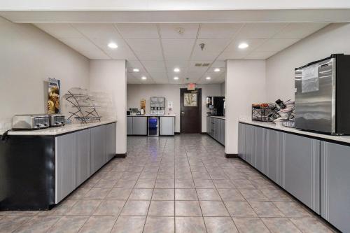 a large room with a lobby with counters and appliances at Microtel Inn and Suites Manistee in Manistee