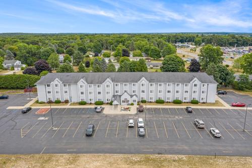 an aerial view of a large white building with a parking lot at Microtel Inn and Suites Manistee in Manistee