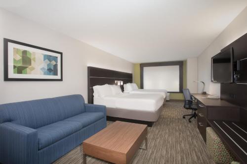 a hotel room with a bed and a couch at Holiday Inn Express Hotel & Suites Longmont by IHG in Longmont