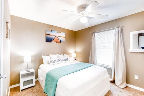 a bedroom with a white bed and a ceiling fan at Sunset Harbour Villas 1-111 in Navarre
