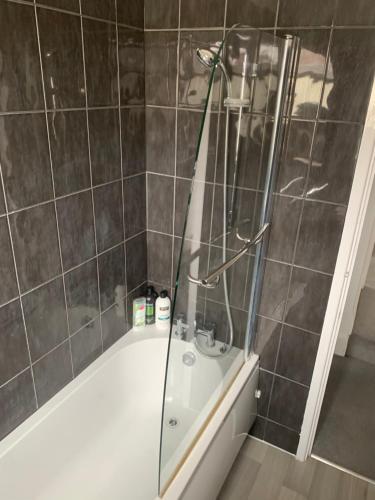 a bathroom with a shower with a tub at Stylish 91sqm Victoria 2 bedroom Apartment in Bristol